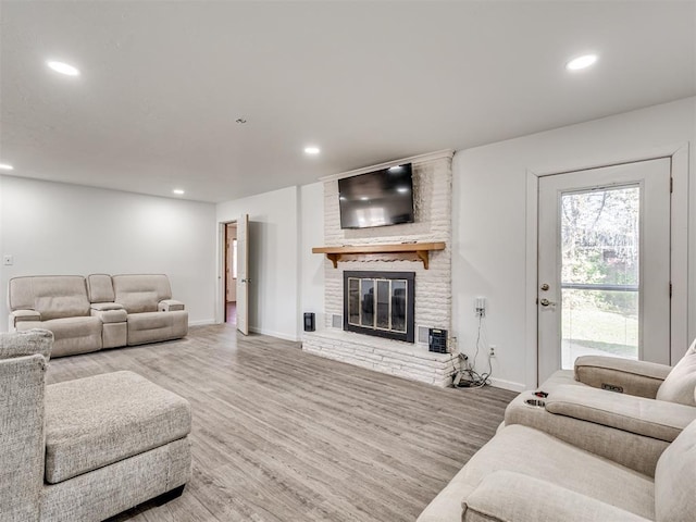 living room with a fireplace and hardwood / wood-style floors