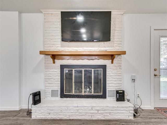 room details with hardwood / wood-style floors and a brick fireplace