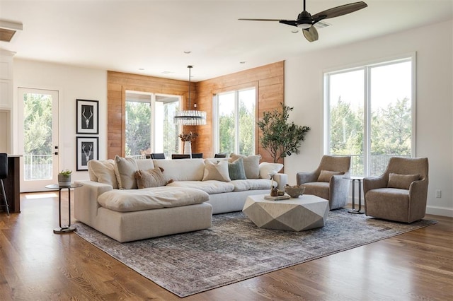 living room with hardwood / wood-style flooring, ceiling fan, and a healthy amount of sunlight