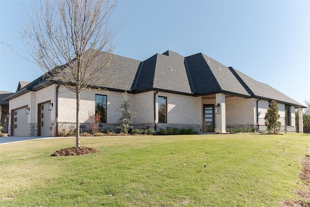 view of front of home with a front lawn and a garage