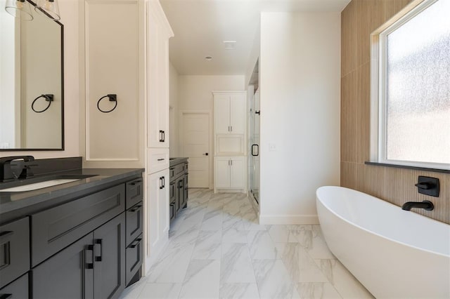 bathroom featuring separate shower and tub, plenty of natural light, and vanity