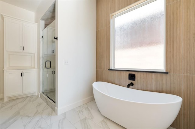 bathroom featuring separate shower and tub and wooden walls