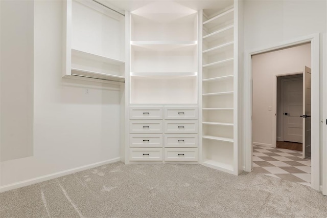 walk in closet featuring light colored carpet