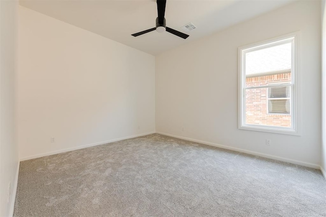 carpeted empty room featuring ceiling fan