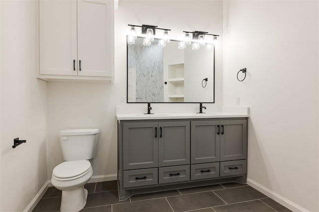 bathroom with tile patterned flooring, vanity, and toilet