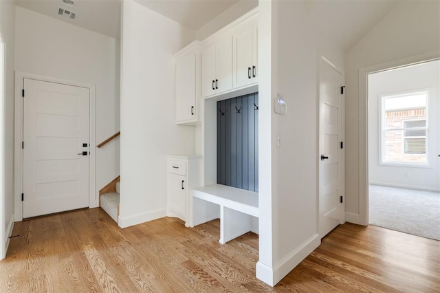 mudroom featuring light hardwood / wood-style floors and lofted ceiling