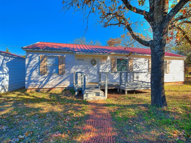 view of front of house featuring a front yard and a deck