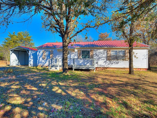 single story home featuring a front lawn and a carport