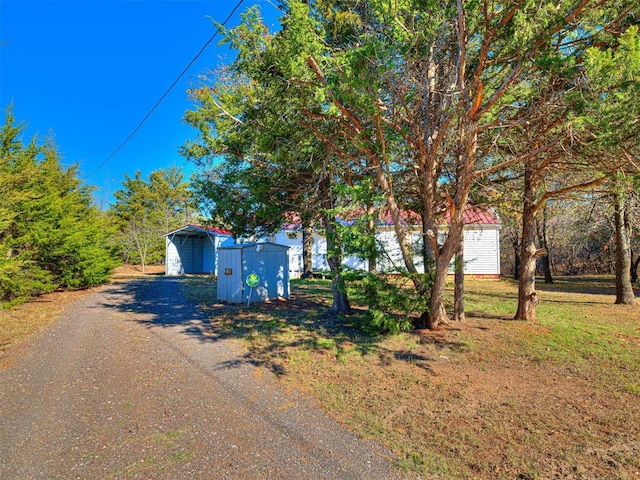 view of front facade featuring a carport and a storage shed