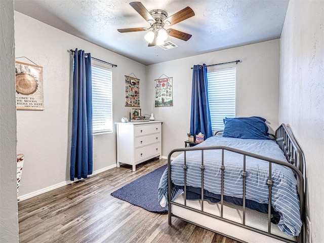 bedroom featuring hardwood / wood-style flooring and ceiling fan