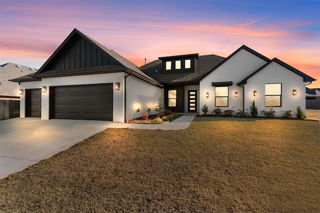 view of front facade with a yard and a garage