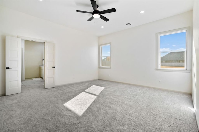 carpeted spare room with ceiling fan and a healthy amount of sunlight