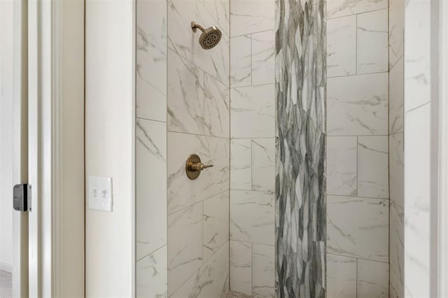 interior details featuring a tile shower