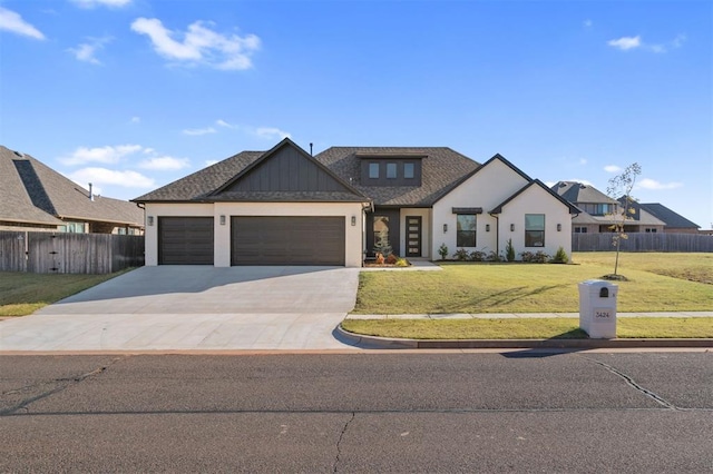 modern inspired farmhouse featuring a garage, driveway, roof with shingles, fence, and a front yard