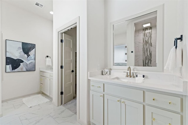 bathroom with marble finish floor, visible vents, and vanity