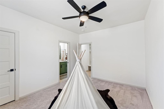 playroom featuring baseboards, a ceiling fan, and light colored carpet