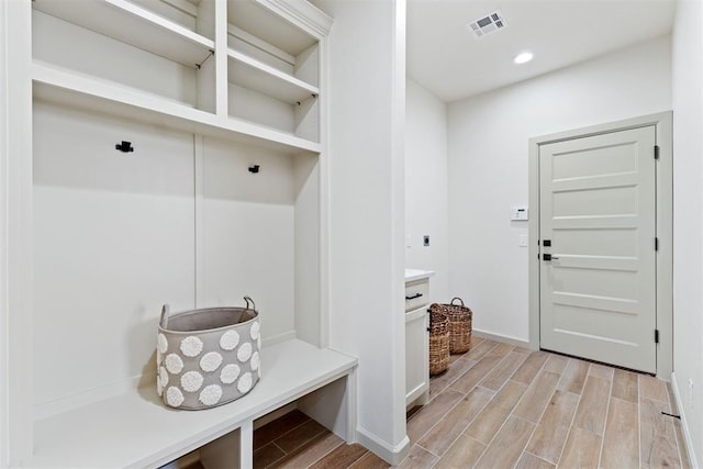 mudroom featuring recessed lighting, visible vents, and wood tiled floor