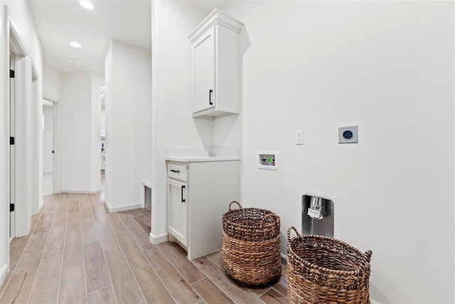 clothes washing area with hookup for a washing machine, recessed lighting, cabinet space, wood tiled floor, and electric dryer hookup