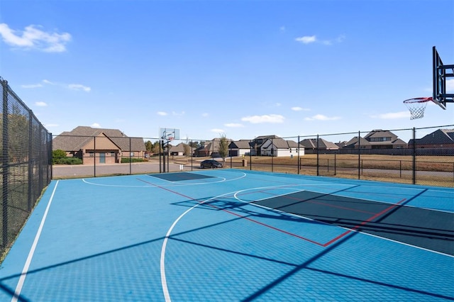 view of basketball court with a residential view and community basketball court