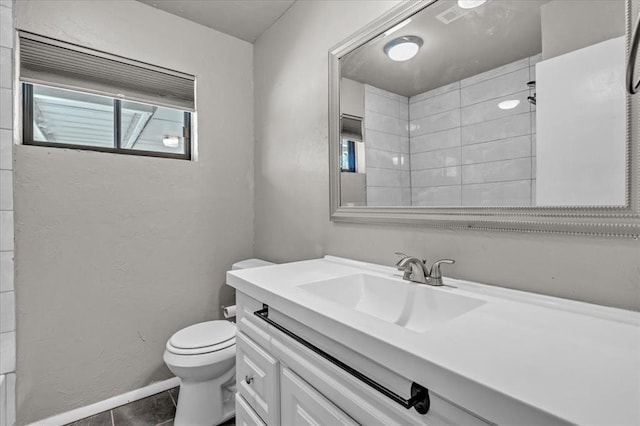 bathroom featuring tile patterned flooring, vanity, toilet, and a shower