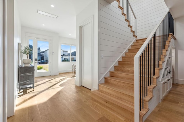 stairs featuring hardwood / wood-style flooring