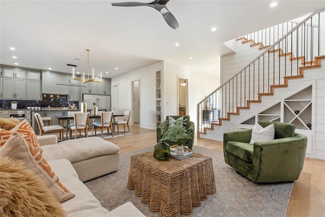 living room with light hardwood / wood-style flooring and ceiling fan