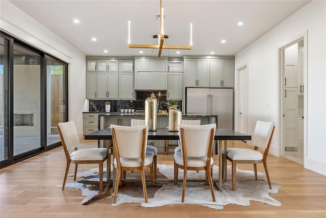 dining room featuring a chandelier and light hardwood / wood-style flooring