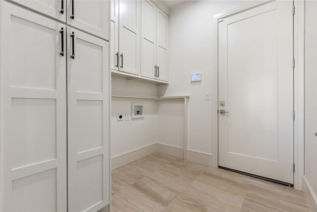 washroom with cabinets, hookup for a washing machine, and electric dryer hookup