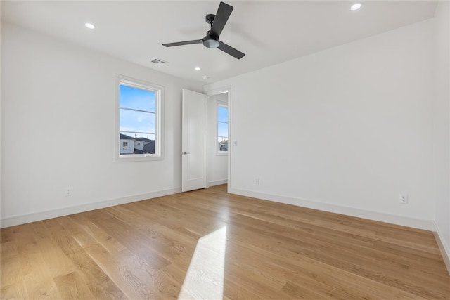 spare room featuring ceiling fan and light hardwood / wood-style floors