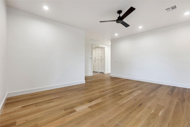 empty room featuring ceiling fan and light hardwood / wood-style flooring