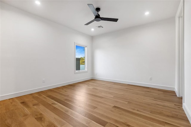 spare room featuring light wood-type flooring and ceiling fan