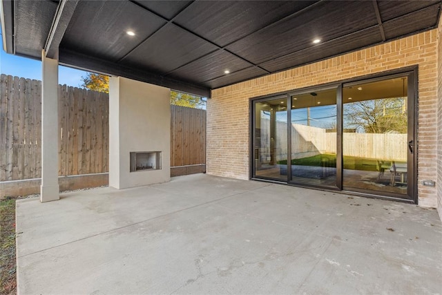 view of patio / terrace featuring an outdoor fireplace