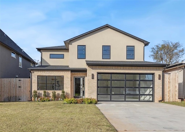 view of front of home with a garage and a front lawn