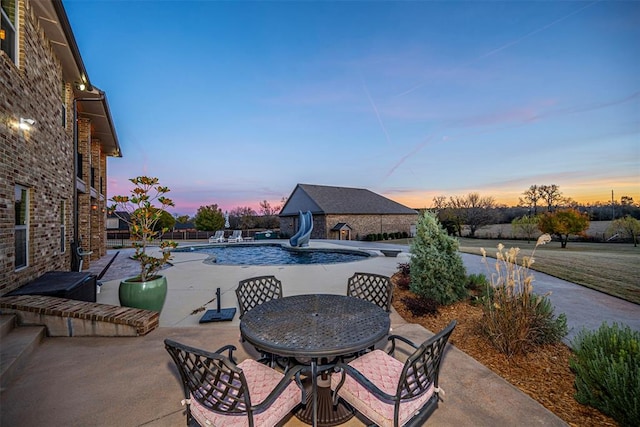 view of patio terrace at dusk