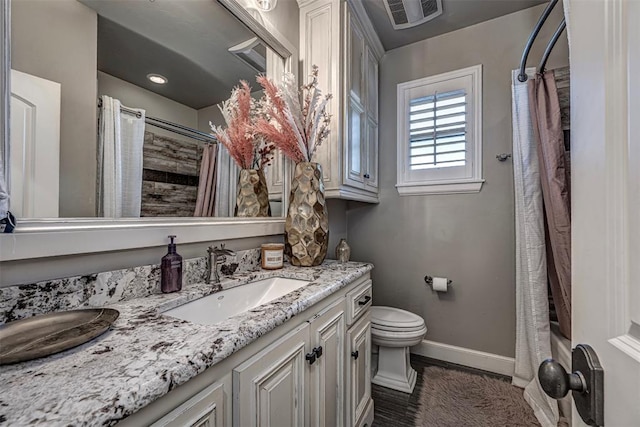 full bathroom with vanity, toilet, and shower / tub combo with curtain