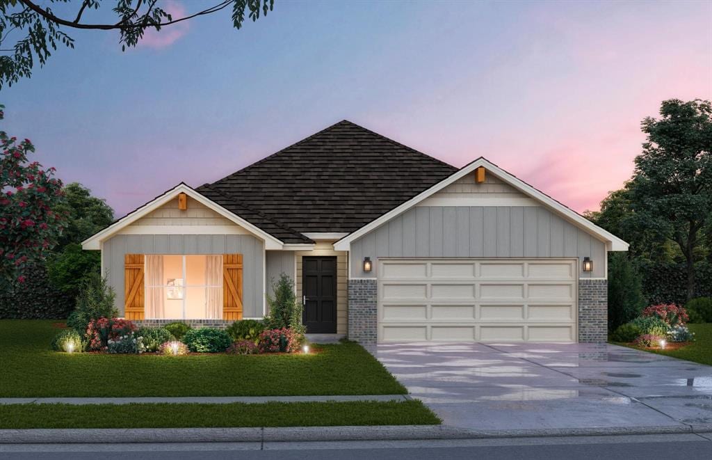 view of front of home with a yard and a garage