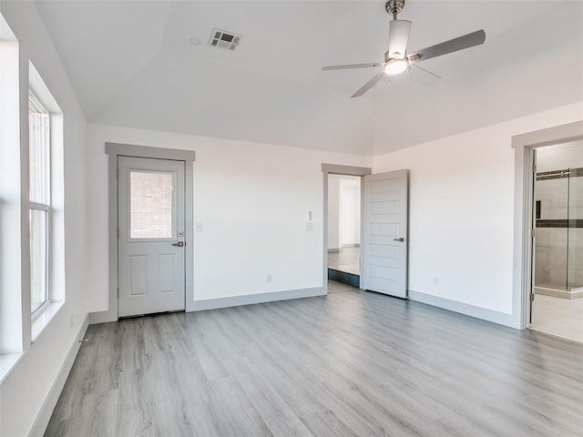 unfurnished room featuring ceiling fan, a healthy amount of sunlight, light hardwood / wood-style floors, and lofted ceiling