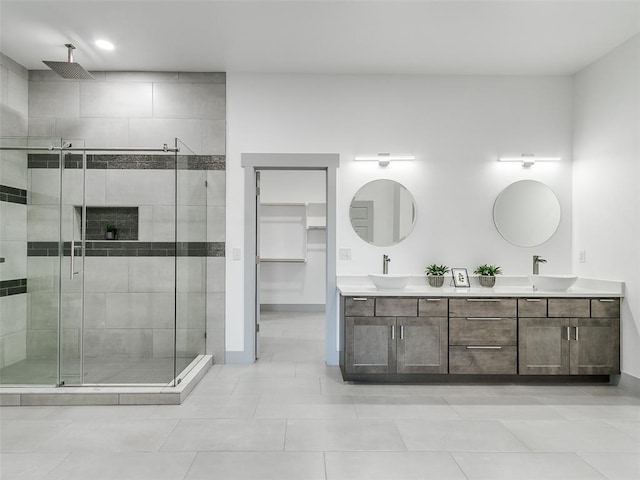 bathroom featuring tile patterned flooring, vanity, and an enclosed shower