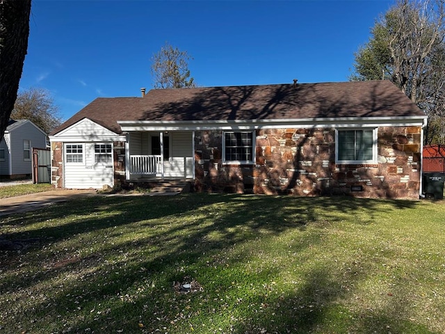 ranch-style house featuring a porch and a front lawn