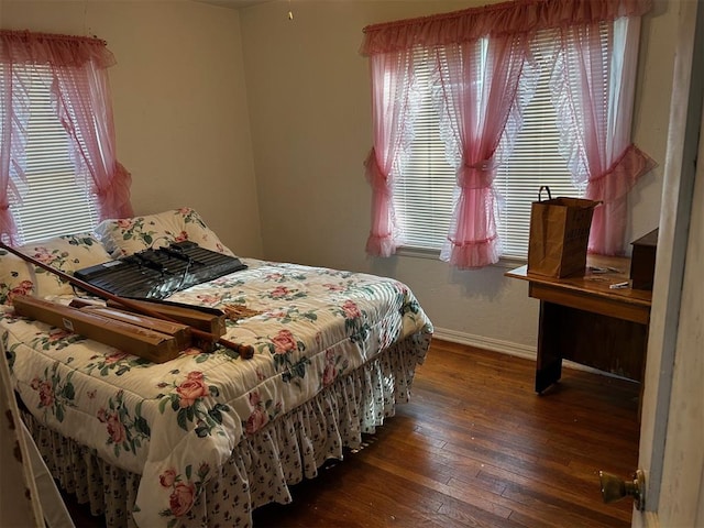 bedroom with dark wood-type flooring