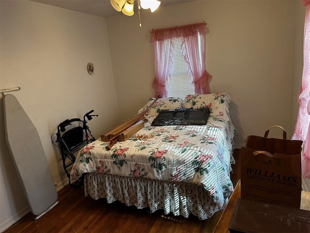 bedroom with ceiling fan and dark hardwood / wood-style flooring