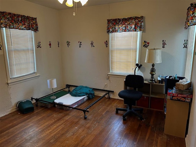 bedroom with dark hardwood / wood-style flooring