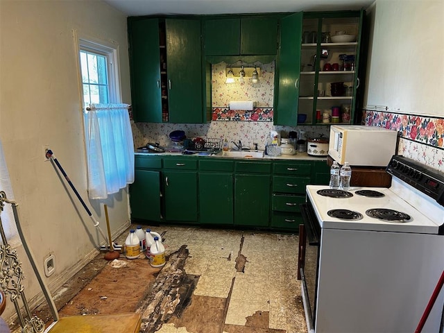 kitchen with green cabinets, white appliances, sink, and tasteful backsplash