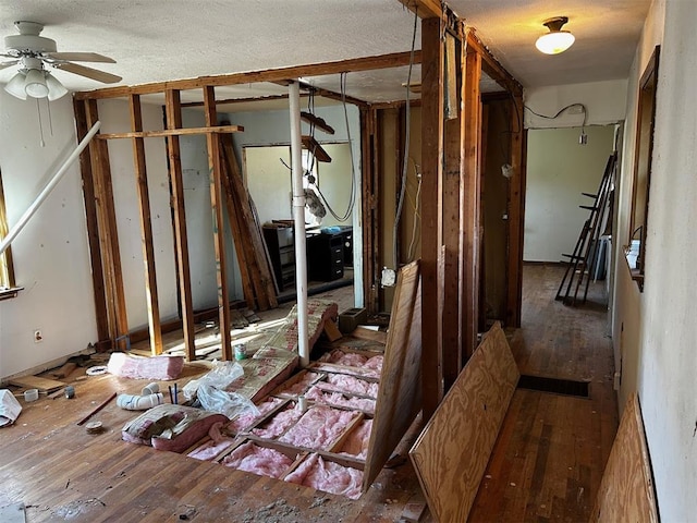 miscellaneous room with ceiling fan, dark hardwood / wood-style floors, and a textured ceiling