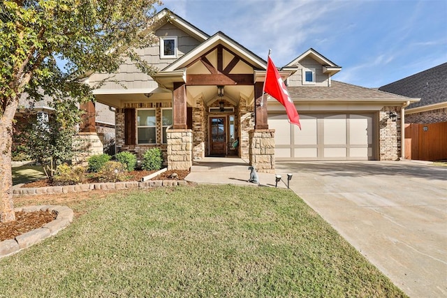 view of front of property with a garage, a front lawn, and covered porch