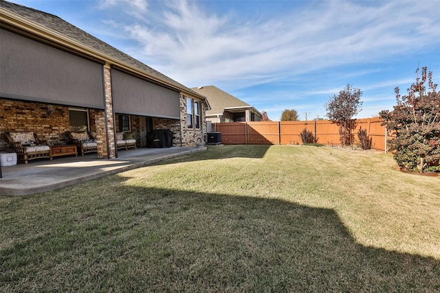 view of yard with cooling unit and a patio