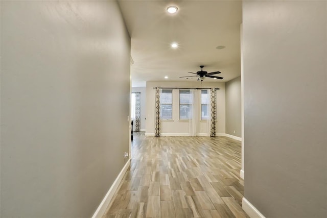 corridor with light wood-type flooring