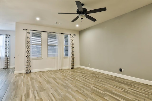 unfurnished room with ceiling fan and light hardwood / wood-style floors