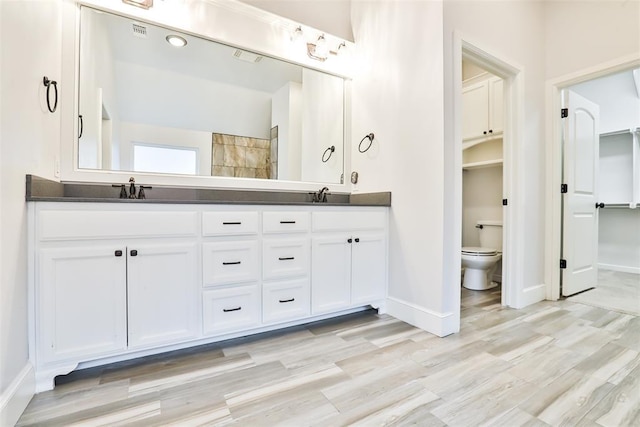 bathroom with vanity, hardwood / wood-style flooring, and toilet