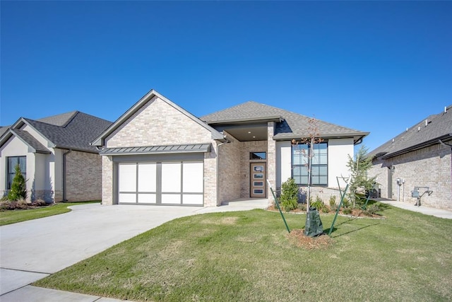 view of front of house featuring a front yard and a garage